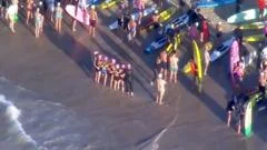 Surfers and swimmers pay tribute to victims of Bondi shooting