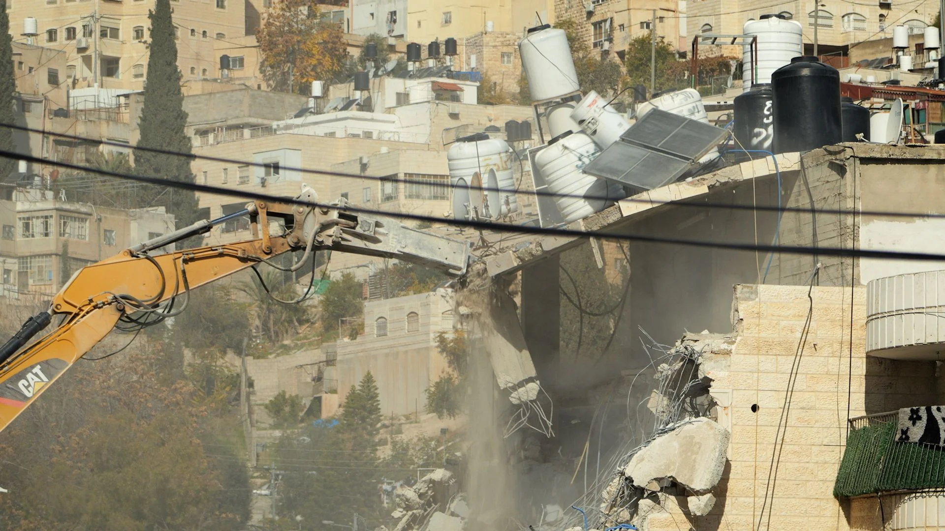 'No one is here to help us': Palestinians watch as Israeli diggers tear down homes in East Jerusalem