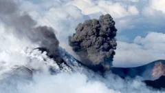 Snow-capped Mount Etna erupts as skiers glide down slopes