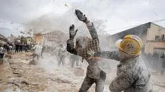 Spaniards hurl flour, eggs and fireworks in mock battle