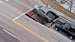 Watch: Moment a sinkhole in Omaha traps cars and drivers