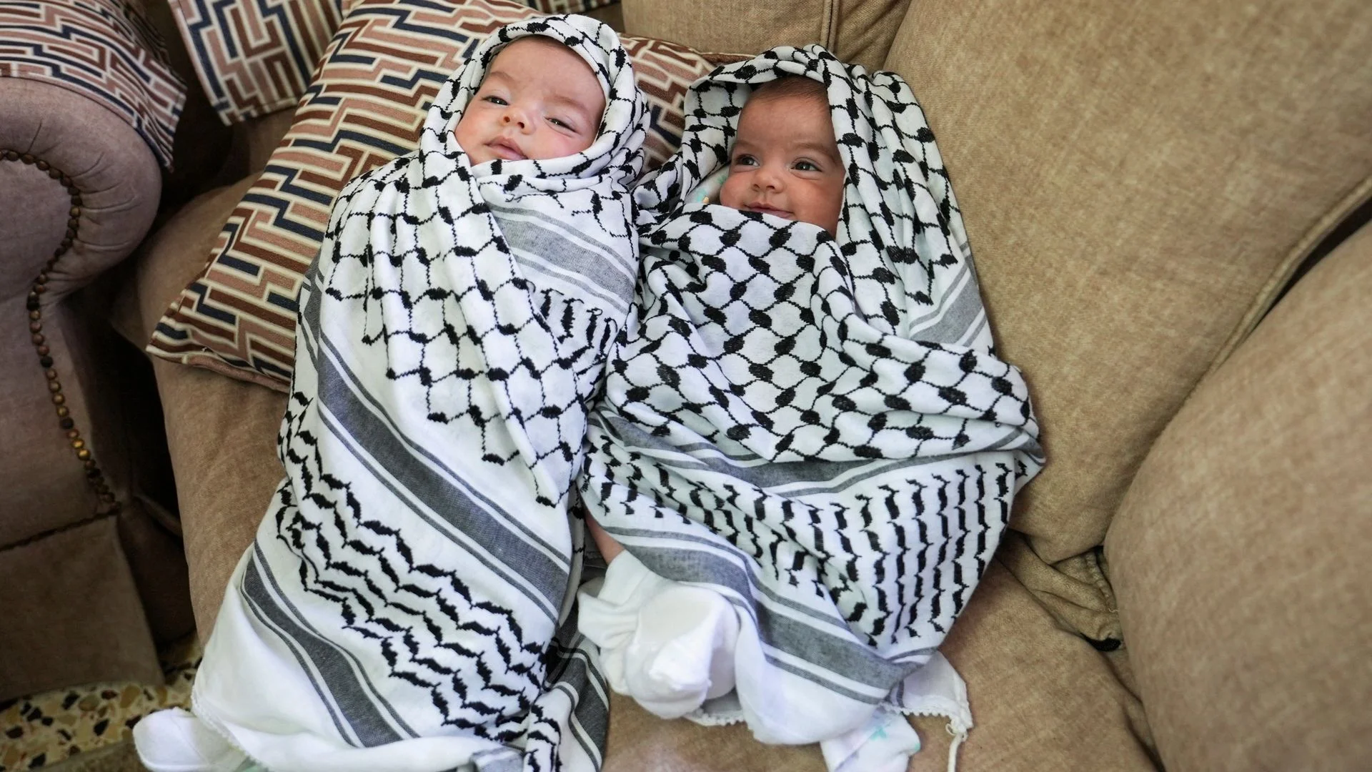 Baby girls held aloft at funeral of father shot during Israeli settler attack
