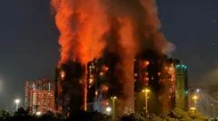 At least 65 dead and hundreds missing after fire engulfs Hong Kong tower blocks
