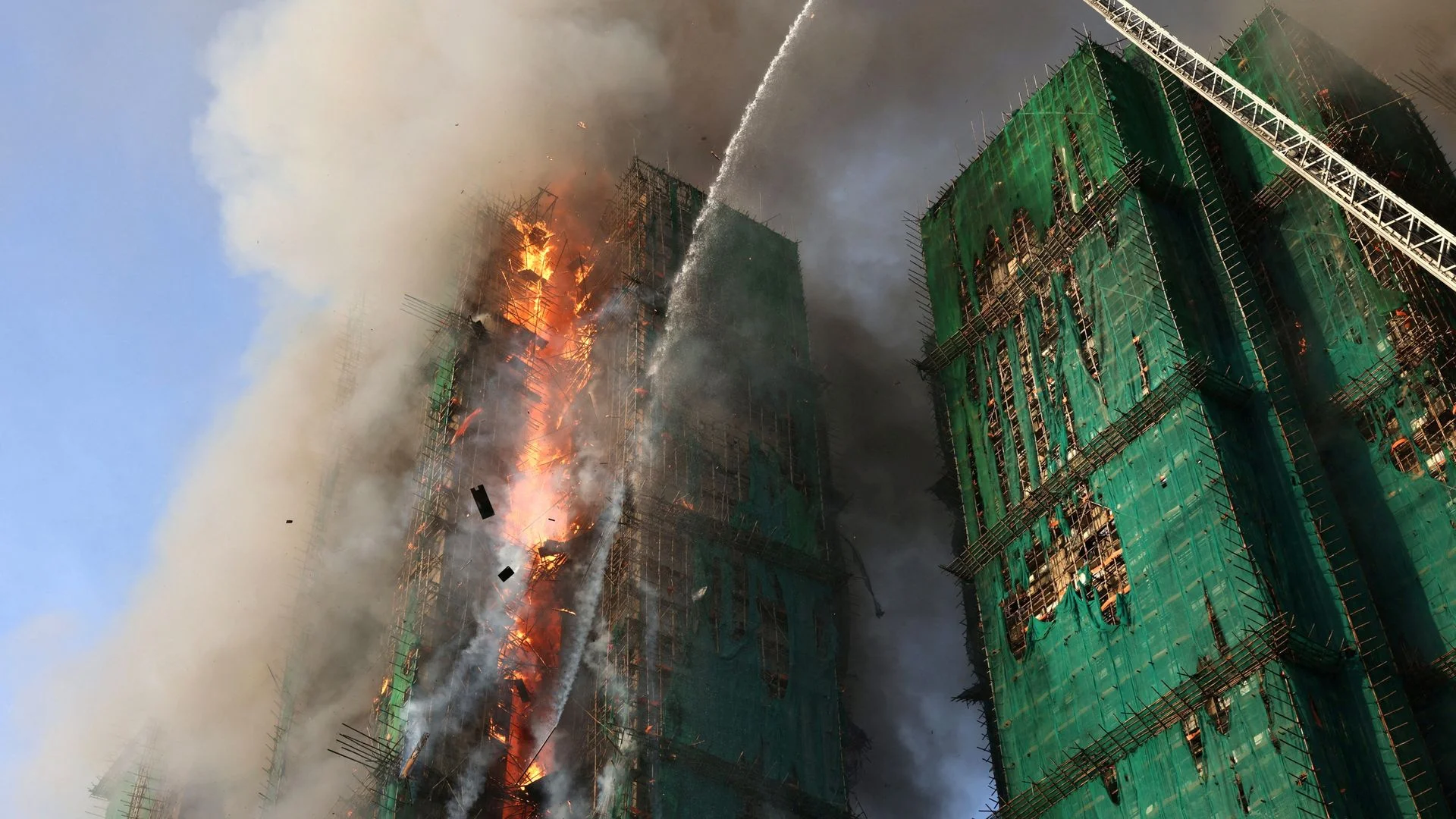 Police make arrests over huge Hong Kong flats fire - with dozens killed and more still missing