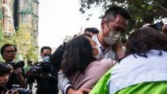 'Hang in there': Agonising wait for the missing after Hong Kong blaze