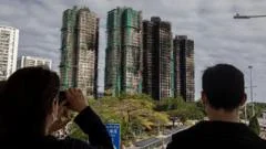 Hong Kong votes in election as city mourns deadly fire